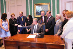 Governor Charlie Baker signs the legislation at the State House. Photo/submitted