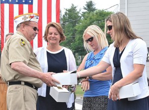 Quartermaster Jim Cabral of VFW Post 1027 presents corsages to Michaud family members: (l to r) Seth’s mother Karen, wife Karen and sister Samantha. 