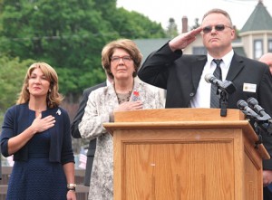 Standing at attention as “The Star-Spangled Banner” is played are (l to r) Lt. Gov. Karyn Polito, state Rep. Kate Hogan and Veterans Agent Brian Stearns.
