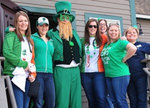 Gathered with an unusually tall leprechaun, aka Chris DiBenedetto, senior vice president and risk officer (third from left), are Horseshoe Pub patrons (front, l to r) Timarly Feeley, Jaime Korkos, Katie Stoico and Sara Walker, and Marlborough Savings Bank staff members (back, l to r) Jennifer Marble, vice president of commercial lending, and Donna Driscoll, named to be Hudson branch manager.