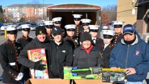 Collecting donations to the Toys for Tots campaign at Walmart are (front, l to r) Officer Joe Kerrigan, his son Patrick, Officer Wendy LaFlamme and Sgt. Tim Boudreau, with cadets of the Marine Corps Junior Reserve Officer Training Corps from Assabet Valley Regional Technical High School. Photo/Ed Karvoski Jr.