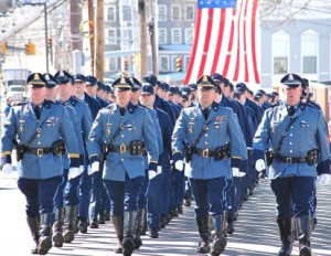 State troopers march on Manning Street toward the church before the service. 