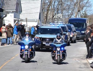 The funeral procession nears Main Street.