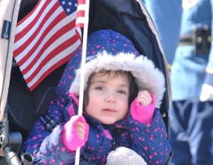 Cora Grunes, 2, watches the procession.