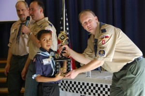 Trevor Catton, Pack 4 Pinewood Derby champion, receives his award.
