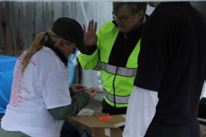 Carolyn Parmenter of Patriot Ambulance teaches a 5k participant how to use Narcan, a drug that can reverse an overdose if administered early enough. Photo/Dakota Antelman