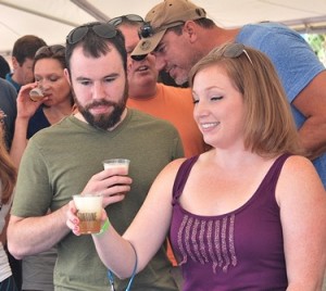 Liz and Nate Tretiak try beer from the Oskar Blues Brewery.