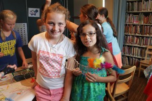 Rachele, 10, stands with her friend Marisa, 9, and her colorful sculpture. (Photo/Julie Shamgochian)