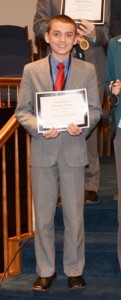 Andrew Brandt of Hudson holds his winning certificate at the regional speech and debate tournament in New Hampshire in April. He was one of seven to advance to the national competition. (Photo/submitted)