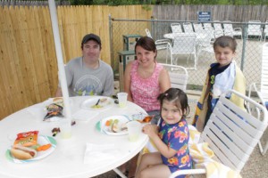 The Skelly children, Brandon and Katie, dry off from the pool and enjoy hamburgers for lunch as a family. 