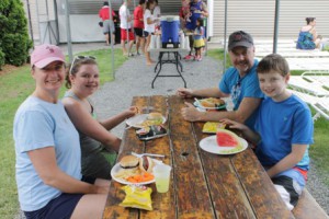 Natalie Beck, 13, and her brother Andrew, 10, enjoy a traditional barbecue meal with their parents. 