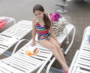 Sarah Brown, 8, relaxes by the pool with a delicious fourth of July meal. 