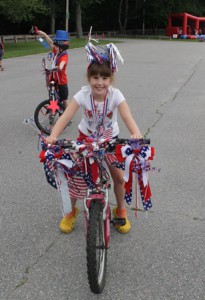  Lily Ruggeri, 7, rides her festive bicycle through Dean Park.