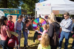 Contestants spin the wheel to win prizes at the Southborough Historical Society booth. 