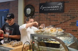 Senior Nick Stukonis of Hudson and instructor Jess Bengtson prepare for the reopening of Assabet Valley Regional Technical High School’s Epicurean Restaurant. (Photo/submitted)