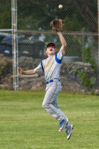 Assabet’s right fielder, William Soto, leaps as he catches a fly ball
