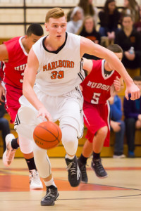 Marlborough’s Chris Doherty moves the ball down the court.