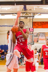 Hudson’s Edrick Meuse looks to the basket as he leaps up to shoot,