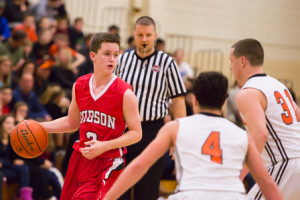 Hudson’s Kevin Wolfe keeps the ball away from two Marlboro defenders.