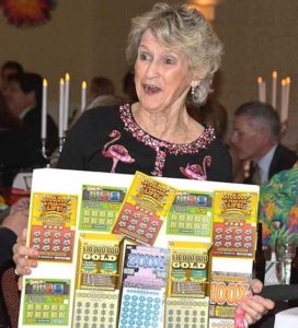 Carol Olson receives the winning raffle prize: $200 worth of state lottery scratch tickets. Photos/Ed Karvoski Jr.