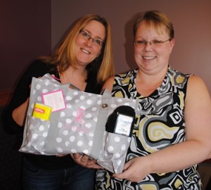 Bridgit Masciarelli, independent director of Thirty-One, with Heather Gould, independent consultant for Thirty-One, with a bag filled with items to help keep those going through chemotherapy more comfortable Photo/Nance Ebert 