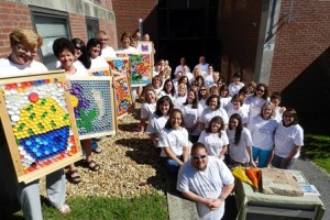 Staff and students of the Marlborough Early Childhood Education Center honor outgoing director Rebecca Zieminski with murals and a rock for the peace garden that she founded. (Photo/submitted)