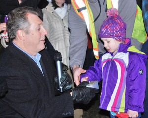 Mayor Arthur Vigeant gets help pressing the button to light the tree from Aurora DeMarco, 4.