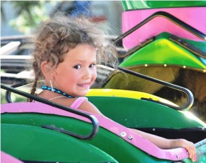 Evalyn Ballesteros, 3, rides on the Dragon roller coaster. 