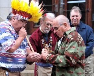 (l to r) Lighting a peace pipe during the opening ceremony are (l to r) Chief Roland Jerome, Noel Rainville and Mike Scelzi of the United Native American Cultural Center in Devens with Mayor Arthur Vigeant.