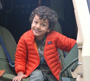 Rayan Hazboun, 4, takes the seat of a National Guard truck.