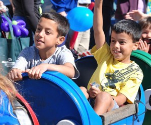 Eight-year-old twin brothers Mateo and Marcos Arellano cruise the Main Street in a trackless train.