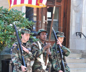 Cadets of the local Civil Air Patrol Color Guard conduct a demonstration in front of City Hall.