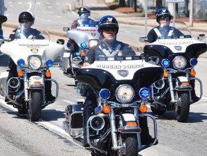 Motorcycle police officers escort the charity ride.