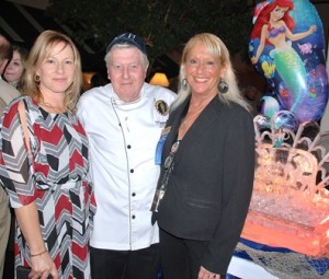 Gathered at the sculpture adorning the shrimp and raw bar are Nanette Roberge and her father Chef Leon Roberge with Debi Webb, food and beverage supervisor of Best Western Royal Plaza Hotel. 