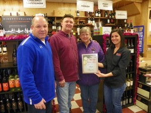 (l to r) Brian Libby, general manager, Sperry’s Liquors; Anthony Speranzella, owner, Sperry’s Liquors; Janet Licht, president of the Marlborough Historical Society; and Lindsay Andrade DiPietro, Carolos Andrade Group, Dunkin Donuts, Metrowest Festival of Trees sponsor. (Photo/submitted)