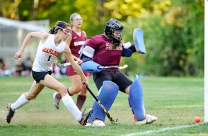 Marlborough High School's Victoria Petrie (#1, left) watches the shot go wide in front of Algonquin Regional High School's Abbie Haskell (goalkeeper).
