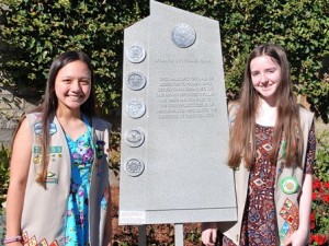 Jackie Forman and Eliana Greenstein Himle of Girl Scout Troop 72855 display their replica of the monument in Women Veterans Park, which will be recognized annually beginning this Veterans Day at the Doughboy Monument.