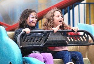 Alecia Maldenado, 9, and Ava Valentin, 8, ride the Sizzler at the carnival.