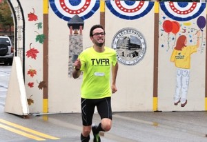 Signaling that the traditional festivities will soon begin Sunday as the conclusion of Heritage Weekend, Chris Kivier nears the finish line of the Main Street Mile and finishes first overall in 4:33. 