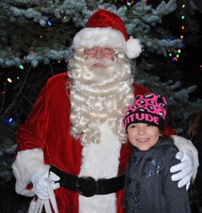 Isabella Lara, 9, poses for a photo with Santa Claus.