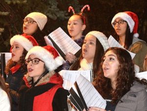 Holiday gear accessorizes some chorus singers’ musical performance.