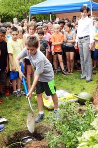 Fourth-grader Nicholas Roca helps bury the time capsule. (Photo/submitted)