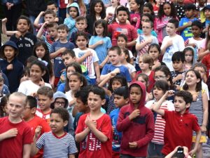 First-graders sing “When the Flag Goes By.”