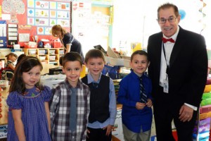 Tuxedoed Interim Assistant Principal Marc Kerble poses with dressed-up kindergartners Lillian Murphy, John Hobin, Aidan Flynn and Bobby Tozzi. 