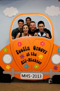 Students pose for a souvenir photo in a VW Beetle  built by parent volunteers.