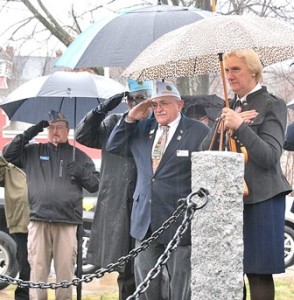 Veterans salute during the Chair of Honor dedication ceremony.
