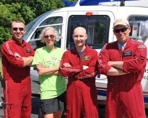 The LifeFlight helicopter crew gathers with Mary Ann Stein, director of volunteer services and community outreach (second from left). When her son Matthew was age 7, LifeFlight transported him and saved his life. 