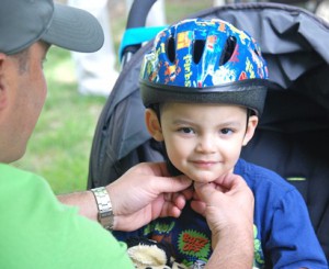 Carlos Camcel, 2, gets fitted for a bike helmet.