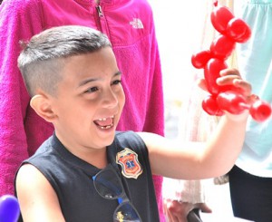 Joshua Lopez, 7, is happy to get a balloon sculpture.
