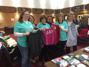 (l to r) St. Stephen Lutheran Church Clothing Giveaway volunteers Liz Greer, Jane Woolsey, Martha Domke, Judy Kellogg, and Lisa Doerr show some of the thousands of free clothing items prior to opening the doors last Saturday morning.